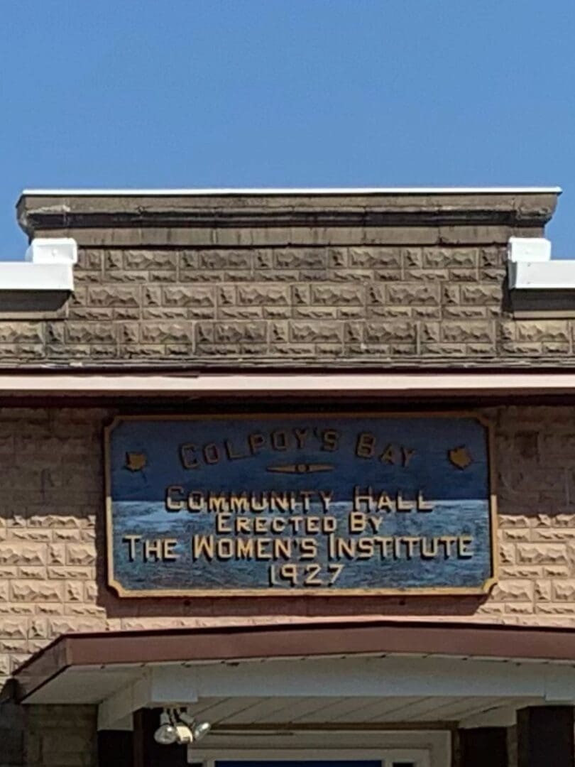 A sign on the side of a building that says " women 's institute ".